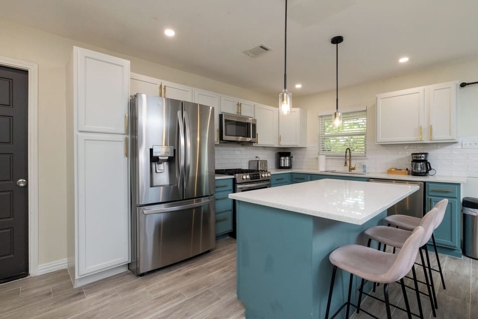 Modern kitchen with full fridge, pantry, and ample island seating