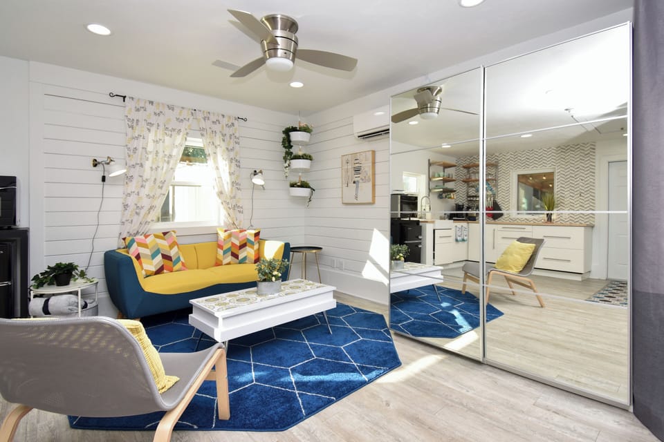 Stylish and spacious living room with lift top table and large storage wardrobe.
