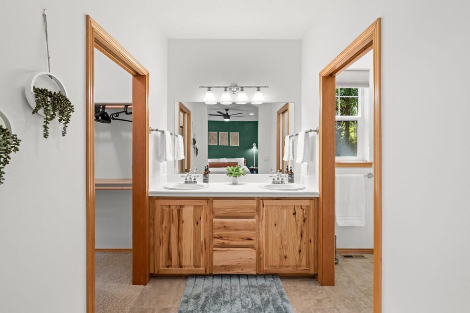 Primary suite bathroom with walk in closet and separate toilet and shower.