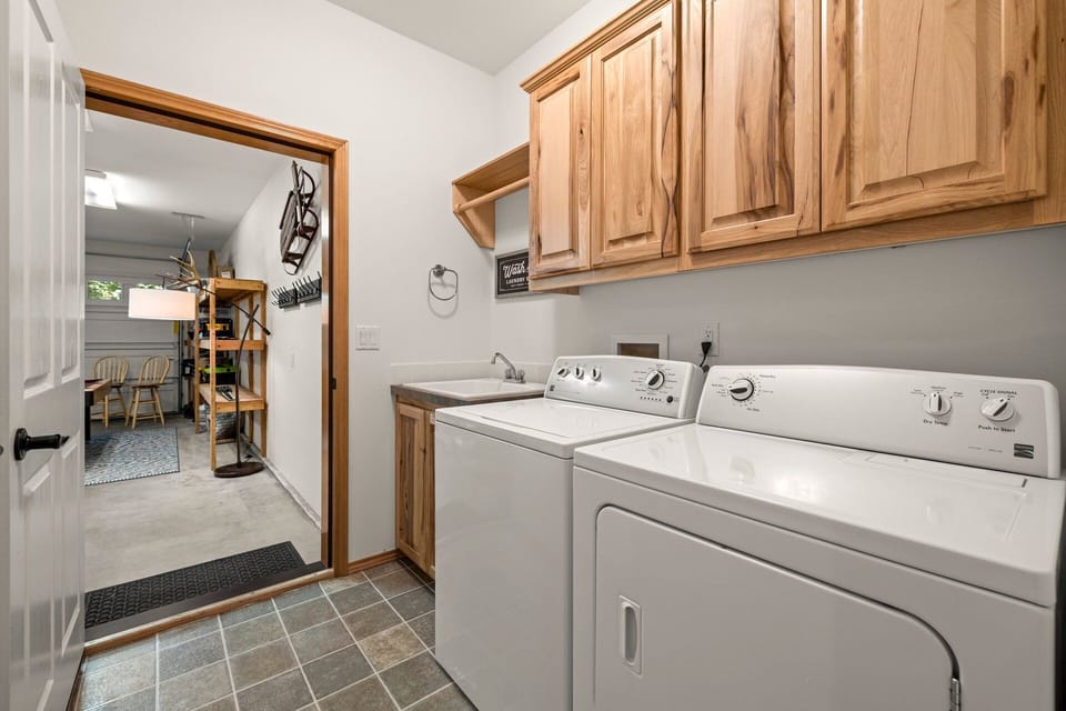 New full washer and dryer set with utility sink.