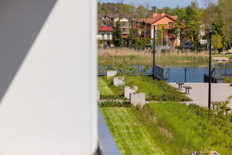 A glimpse of the outdoor area with landscaped gardens and nearby walking paths.

