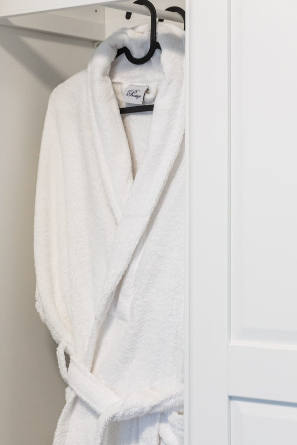 A close-up of neatly arranged white robes, emphasizing the hotel-like experience for guests.
