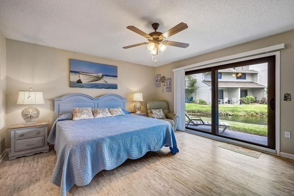 Primary Bedroom with Patio Access and Water Views