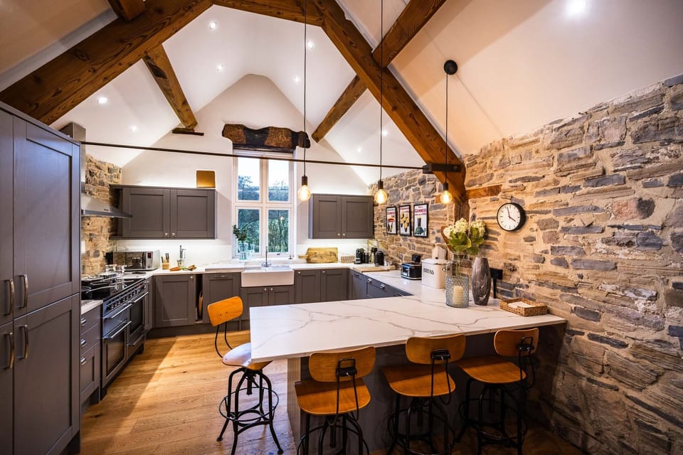 The stunning kitchen has vaulted ceilings, original beams and lots of light.
