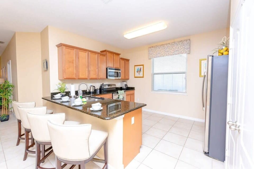 Ample breakfast bar with 4 comfortable chairs.