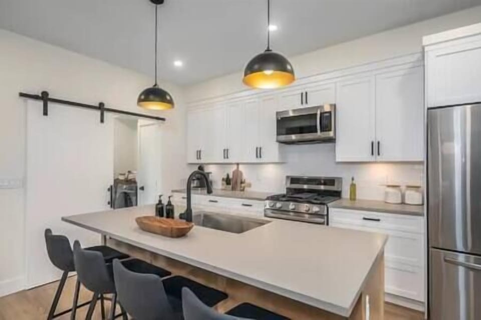 Modern kitchen with stainless steel appliances, large french door fridge, and freezer combo. 