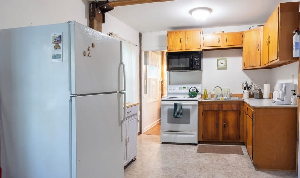 A cozy, fully stocked kitchen is at your disposal for cooking.