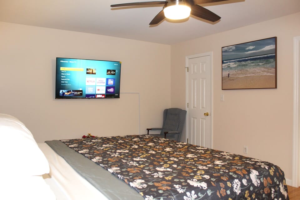 Master bedroom with luxurious king bed, dresser, and attached bathroom & closet