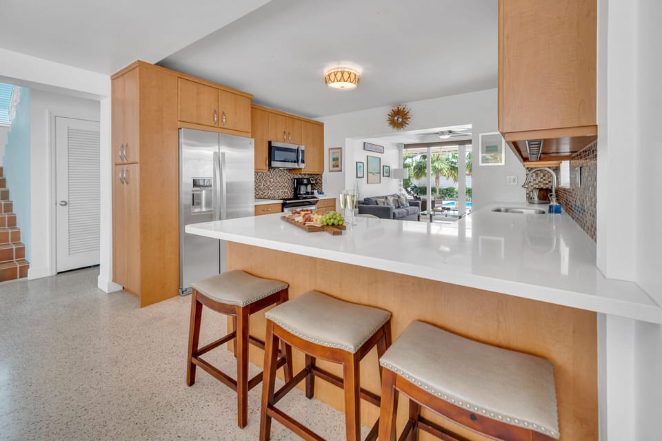 Experience culinary bliss in our open kitchen, complete with bar stools that invite conversation and comfortably accommodate up to three guests.