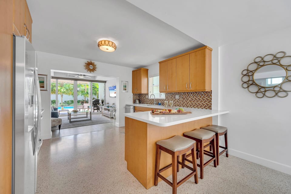 Experience culinary bliss in our open kitchen, complete with bar stools that invite conversation and comfortably accommodate up to three guests.