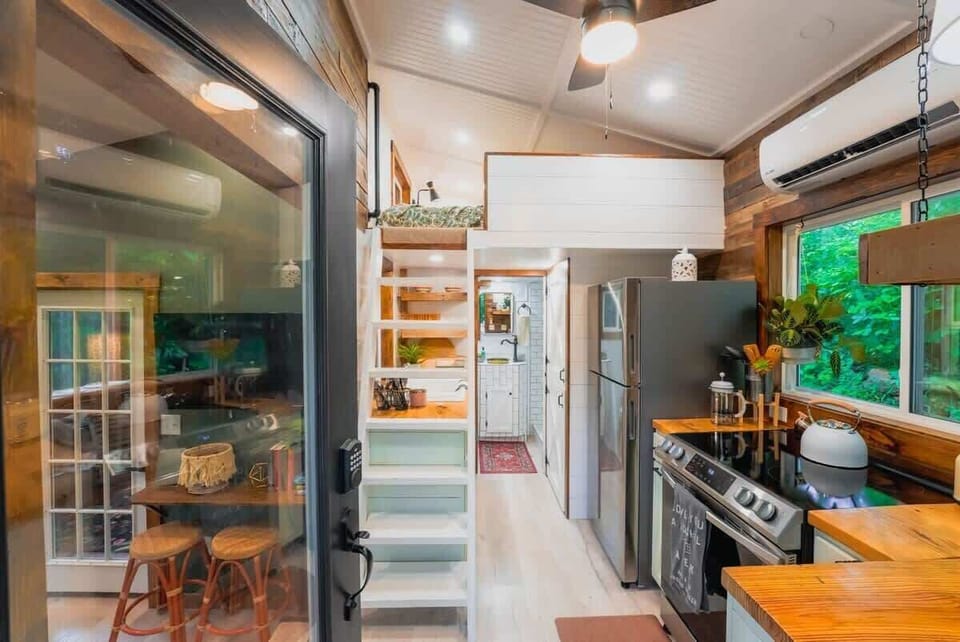 🏡🌳 Our tiny home blends modern comforts with rustic charm, connecting you to nature inside and out.