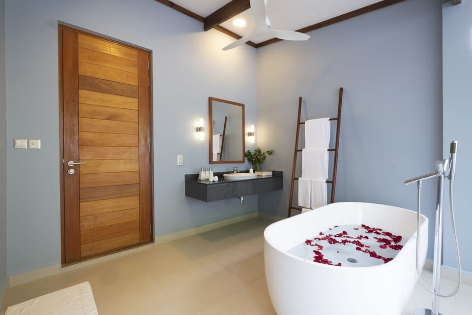Designer toiletries, hair dryer, slippers, towels