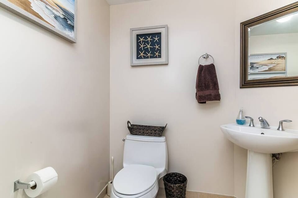 Convenient half bathroom with essential amenities.