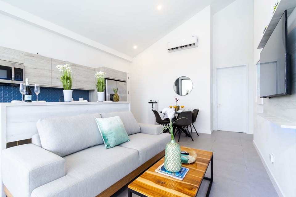 Unwind in your bright, open living area with plush seating, modern touches, and seamless flow into the dining space—perfectly designed for your comfort and relaxation.