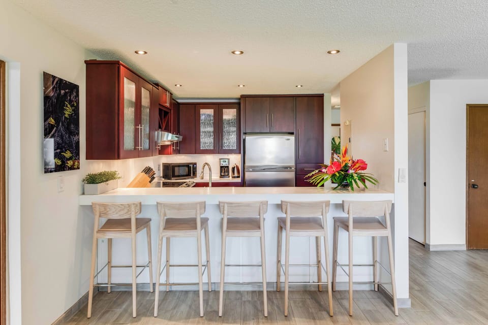 Prepare meals in style with smooth Corian countertops, modern appliances, and plenty of prep space for island feasts.