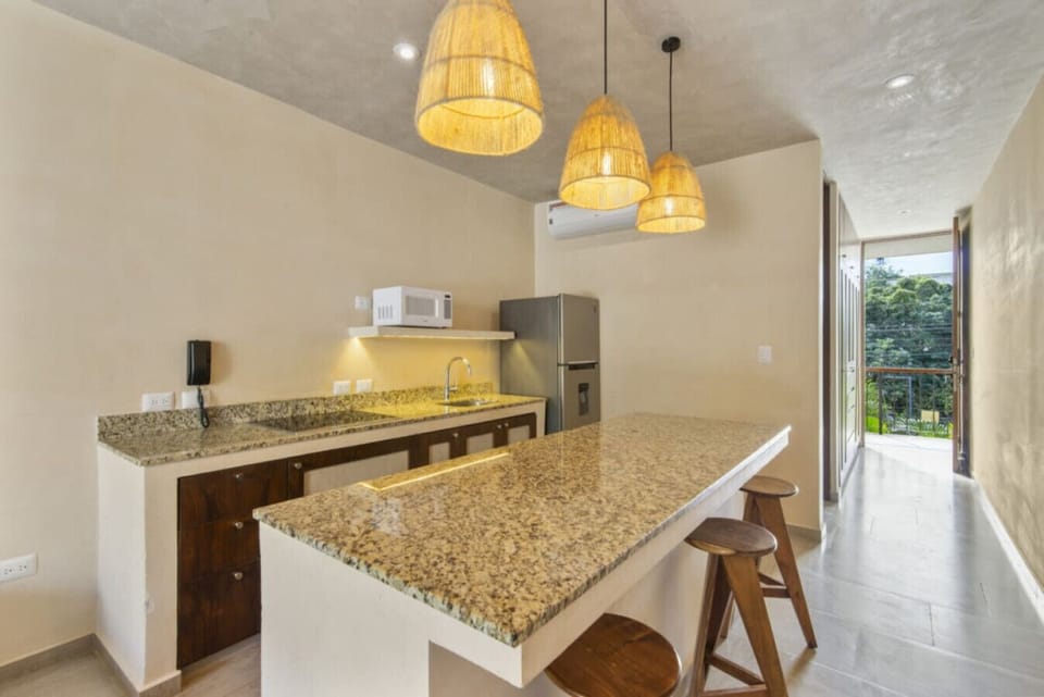 Modern kitchen with bar stools and soft lighting for easy dining.