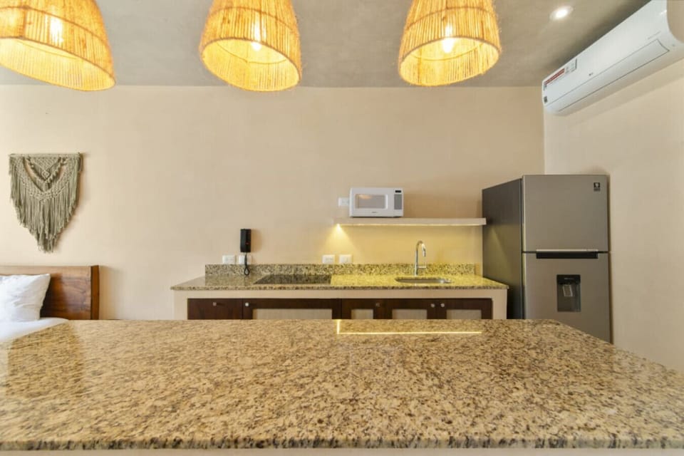 Stylish kitchen with granite, cozy lighting, and all the essentials.