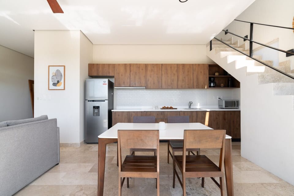 Modern kitchen with wood tones and dining for four.