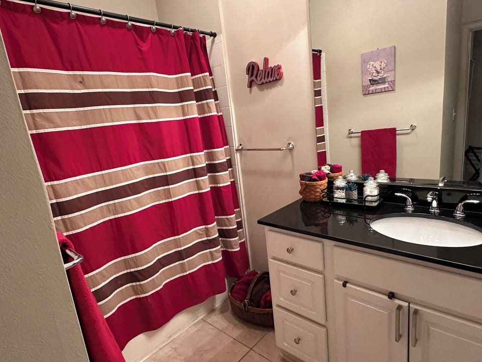 Guest Bathroom with towels, soap, shampoo, and hairdryer.
