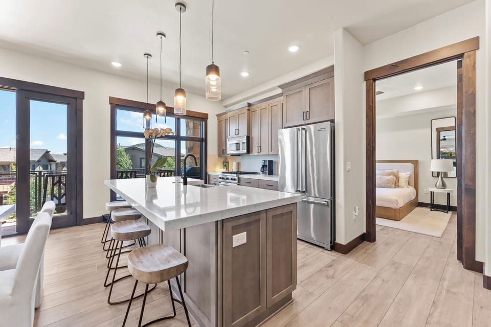 Modern kitchen with stainless steel appliances, a large island, and everything needed to prepare meals with ease.