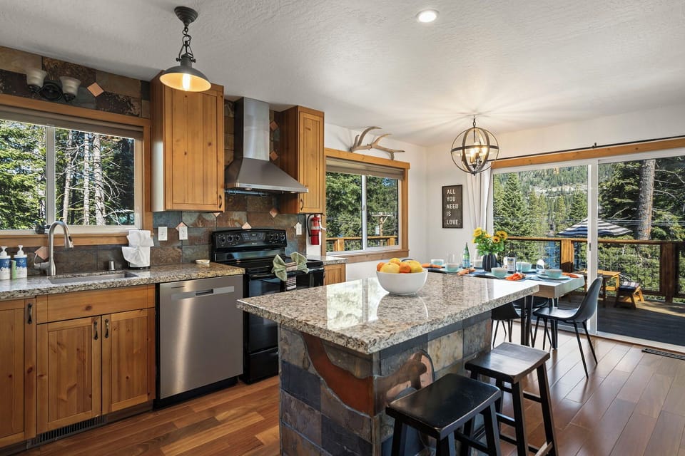 Your spacious mountain kitchen offers granite counters, stainless appliances, and forest views while you cook and dine together.