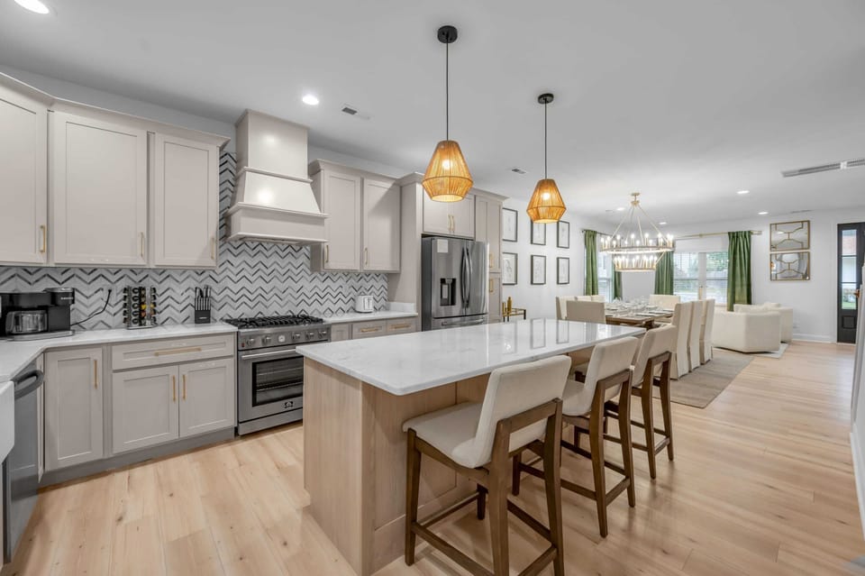Enjoy meals or quality time in this light-filled dining space and kitchen, designed for comfort and connection with its spacious setup and inviting atmosphere.
