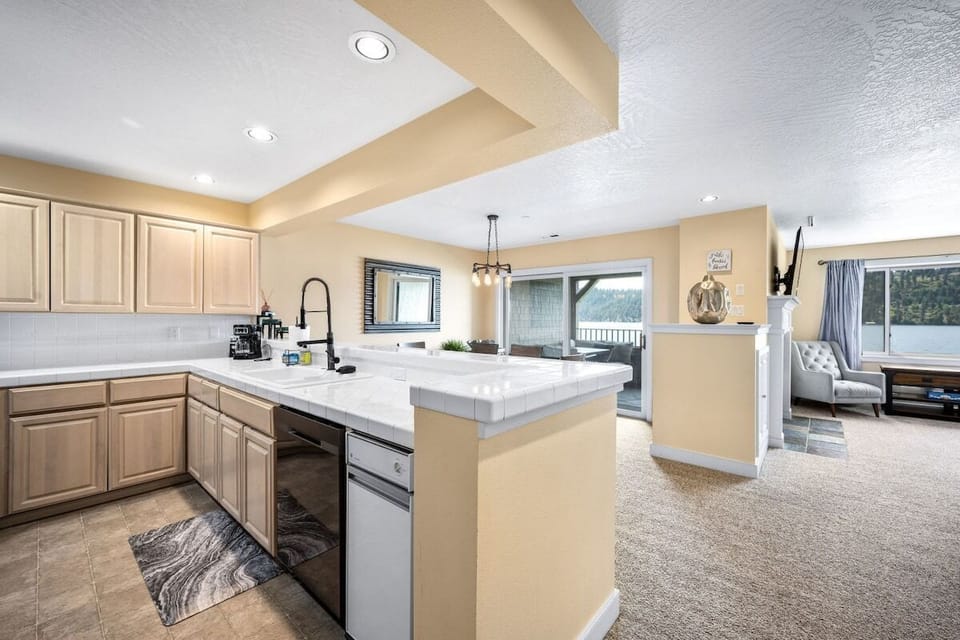 Your spacious kitchen features marble countertops and opens to a cozy living area with stunning lake views—perfect for morning coffee.