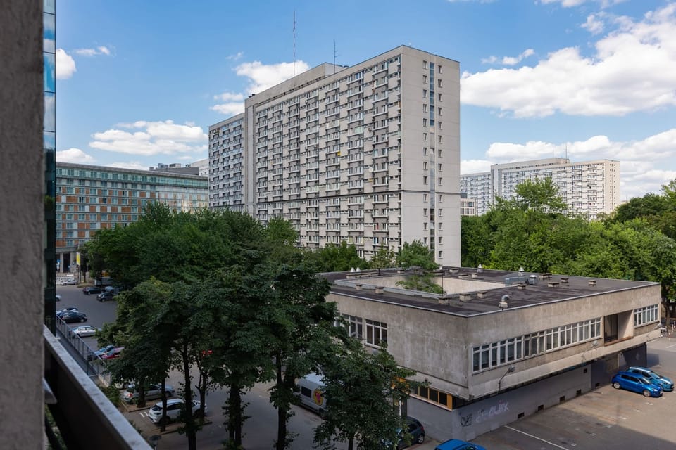 A panoramic view of the apartment complex surrounded by greenery, blending urban living with natural elements.





