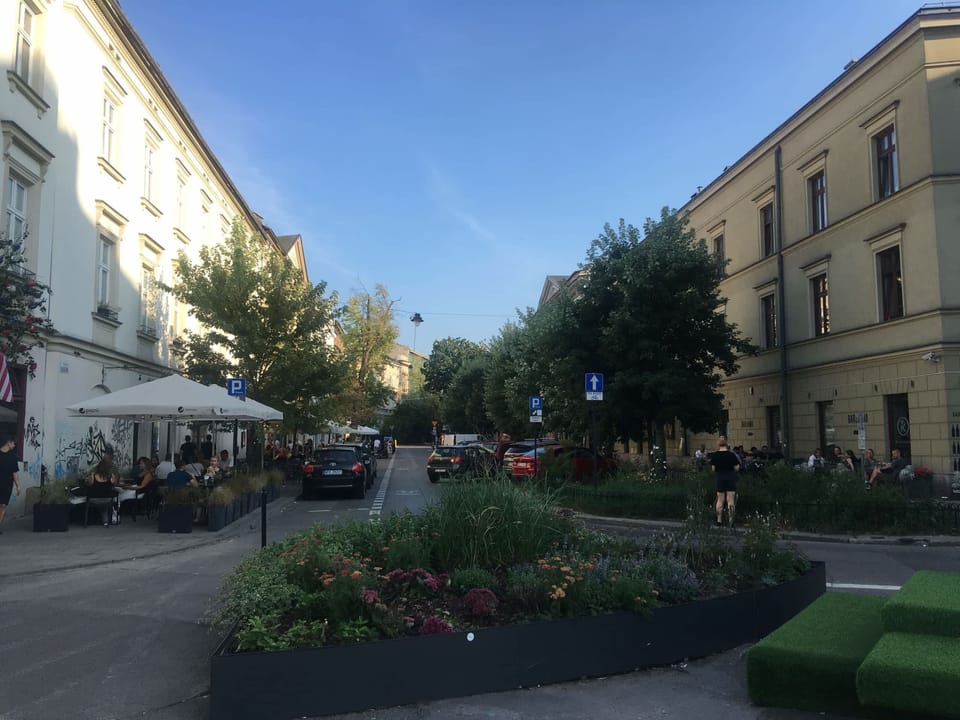 Greenery-filled outdoor seating area near the apartment, perfect for relaxation and leisure.






