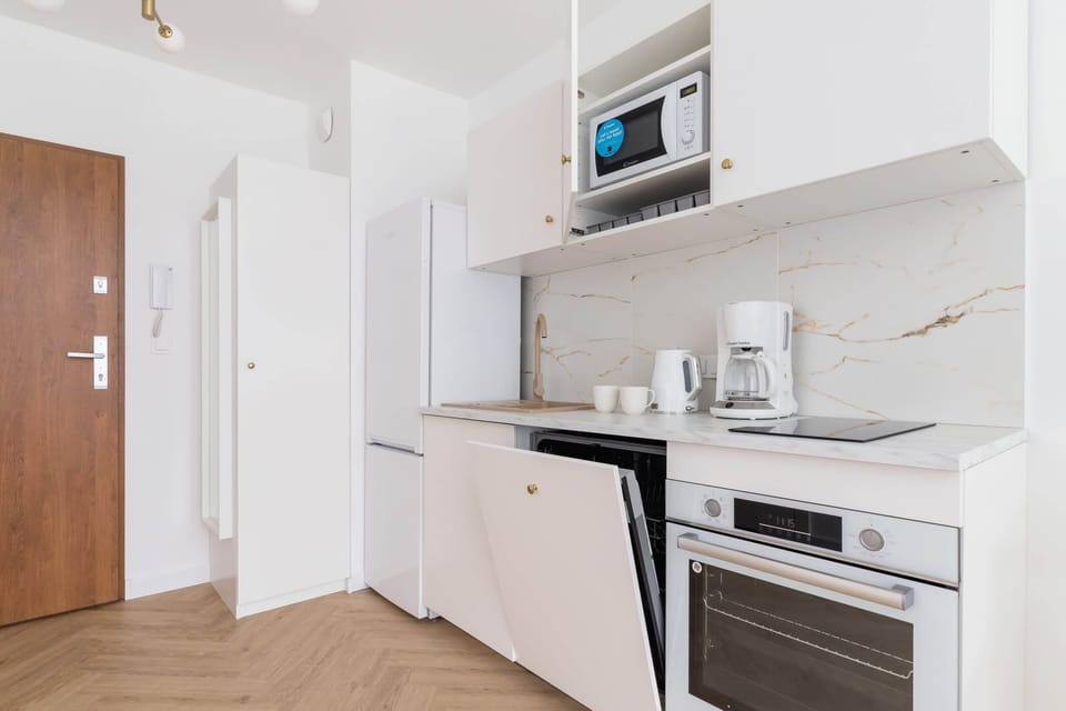 Kitchen with a built-in microwave, oven, and dishwasher, providing convenience and practicality.

