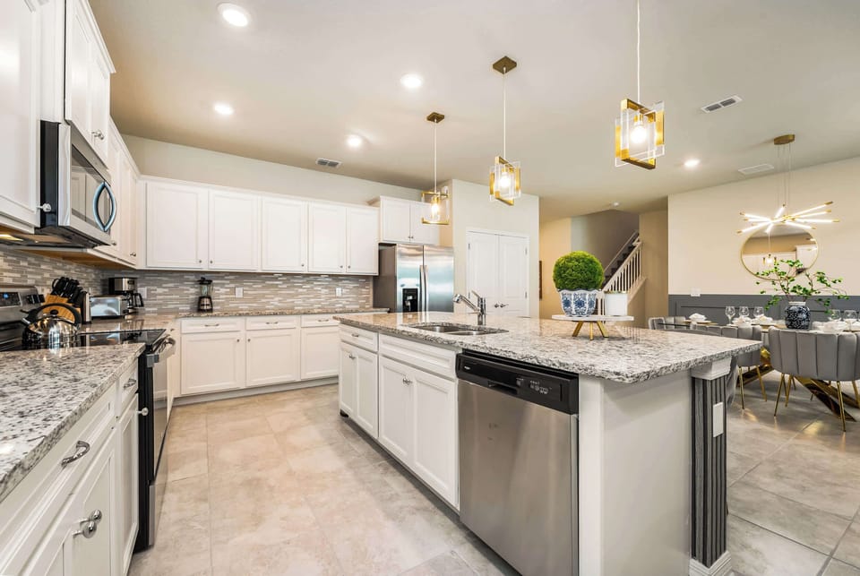 Elegant kitchen with granite countertops and modern appliances, perfect for hosting and cooking with ease.