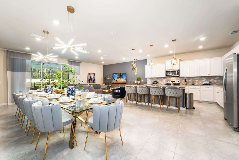 Elegant open-plan dining and kitchen area perfect for large gatherings, featuring modern amenities and stylish decor.