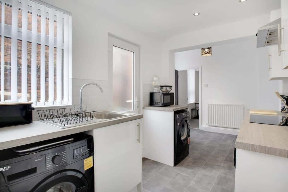 Kitchen equipped with all essentials, including a washer & dryer, oven, fridge and full cookware set.
