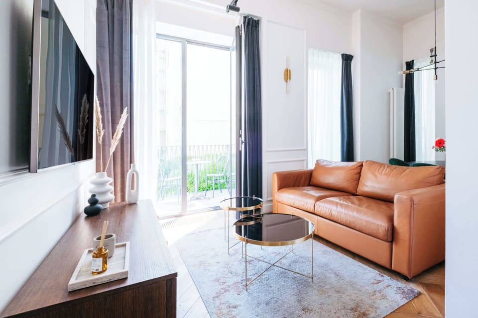 The living room with convertible soba bed, TV with Neflix and access to the balcony