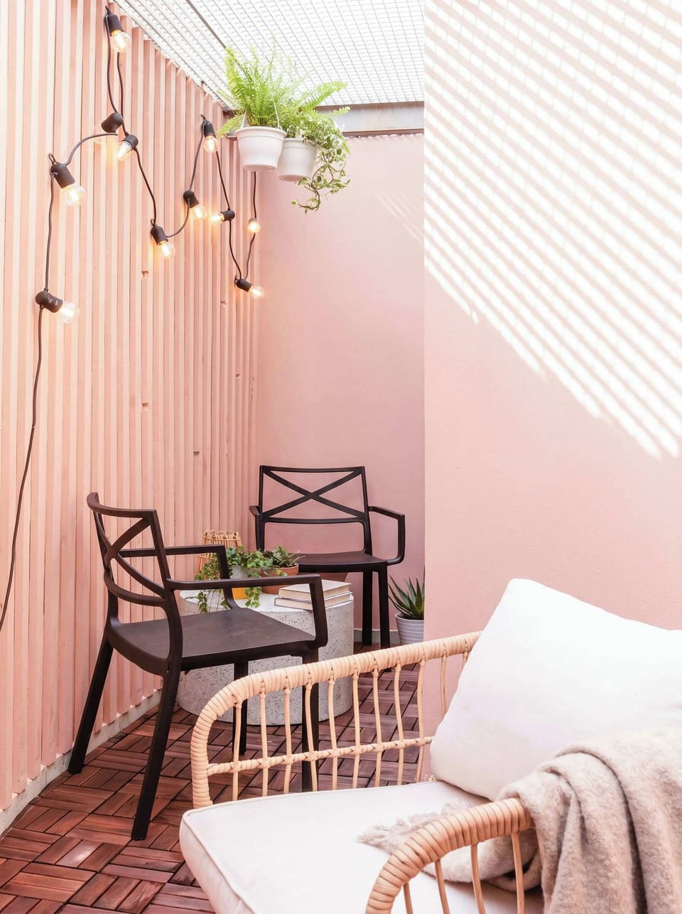 Cozy private patio on the lower-ground level, perfect for a quiet coffee or a moment outdoors. The patio sits beneath an elevated exterior walkway serving the building.