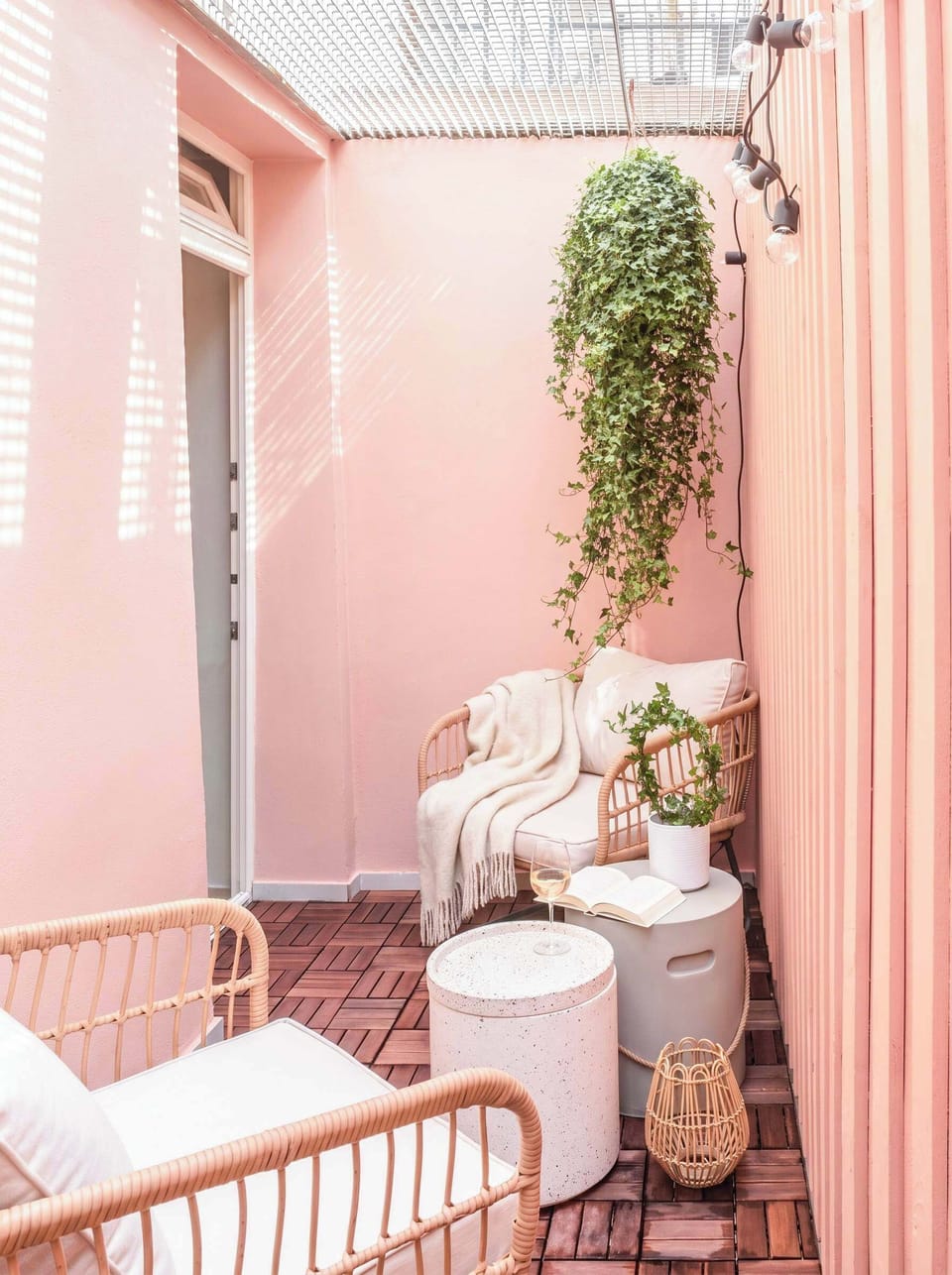 A cozy private patio on the lower-ground level, perfect for a quiet coffee or a moment outdoors. The patio sits beneath an elevated exterior walkway serving the building.
