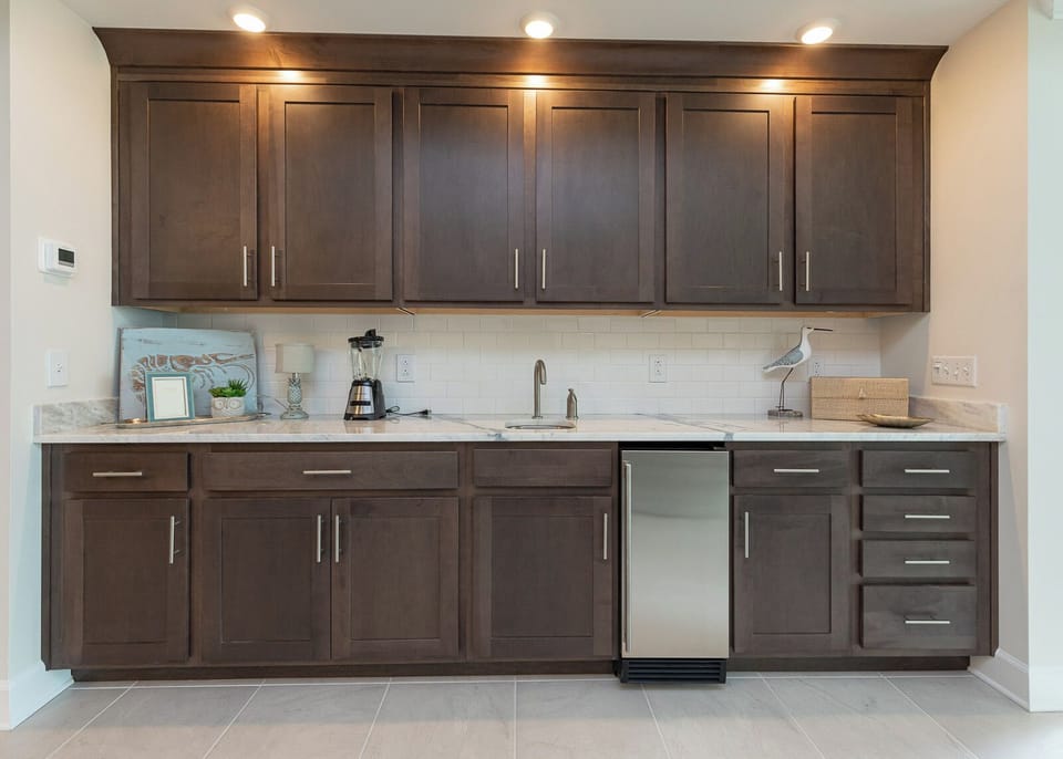 Enjoy prepping drinks at the wet bar, featuring a blender and mini fridge