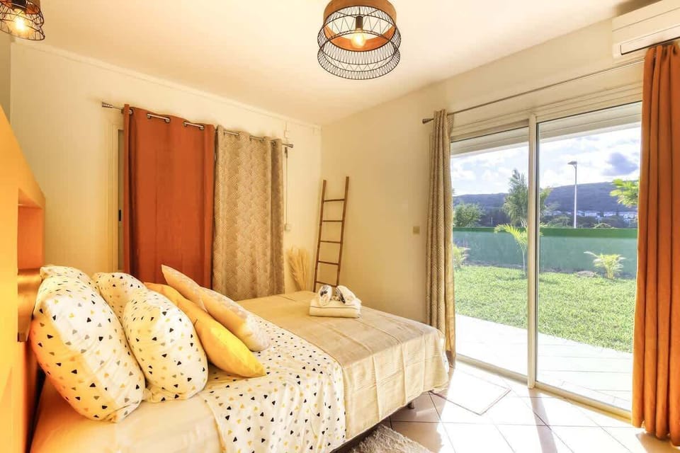Grande chambre équipée d'un lit queen size donnant directement sur le jardin