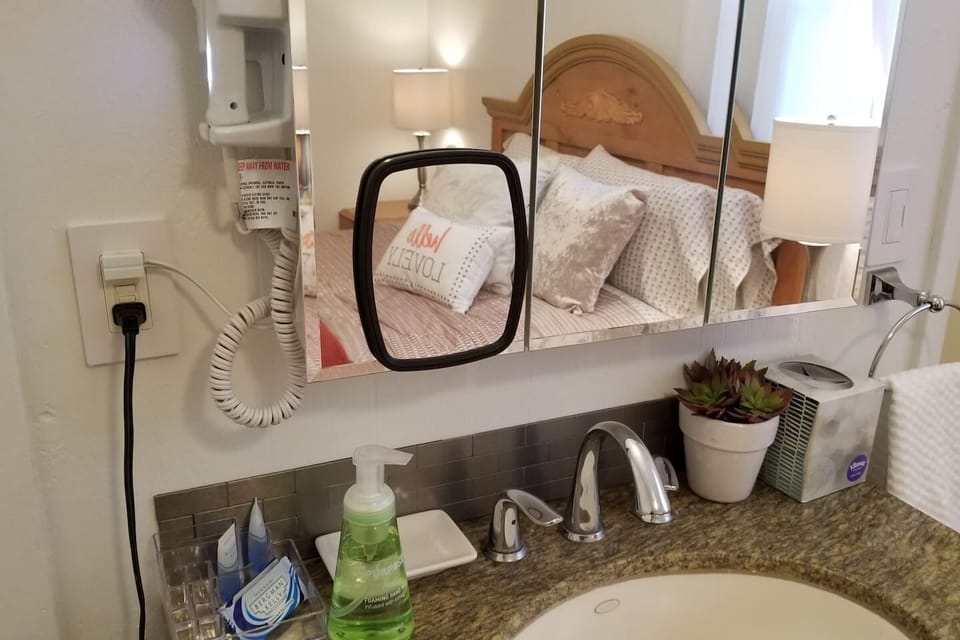 Gorgeous Granite Topped Sink Chest with stainless steel mini subway style backplash. Includes wall mount hairdryer with nightlight too!