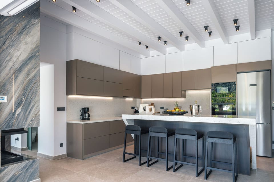 An island counter featuring four stools for casual dining!