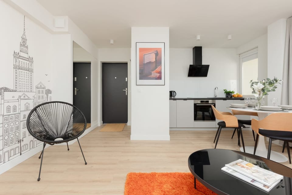 Relaxing seating area with modern black chairs and a decorative mural of the cityscape.

