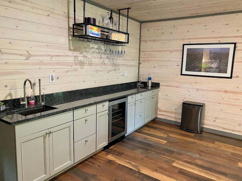 Bar with wine fridge on lower level