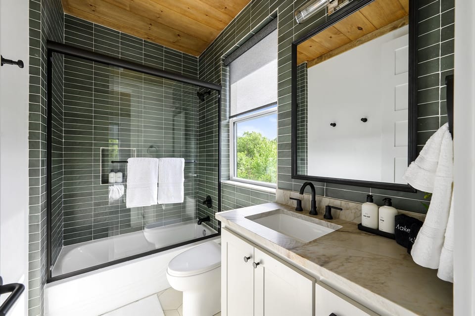 En Suite Bathroom: Refresh in style with sleek finishes and a serene view!