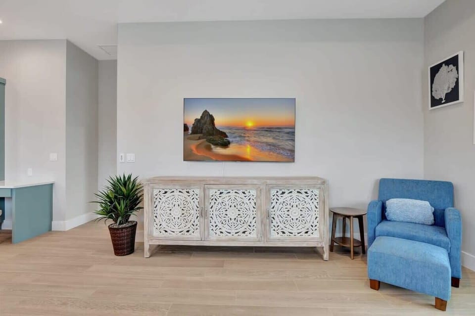 A large screen TV is hung in the family room for your entertainment