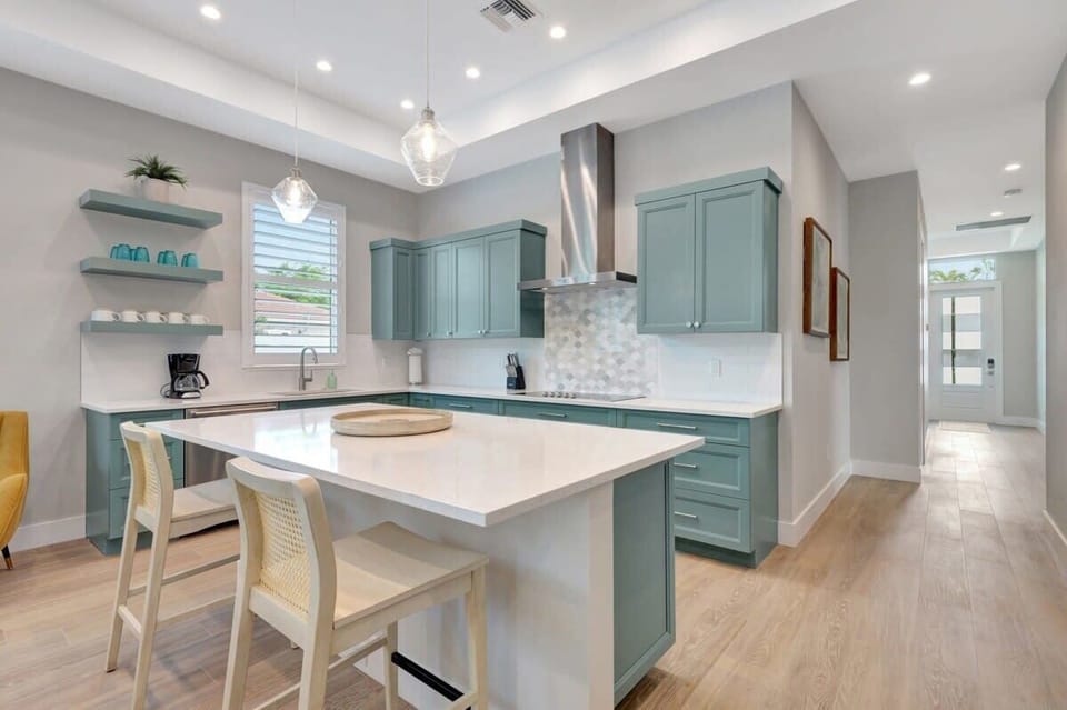 Gather around the inviting kitchen island, complete with comfortable dining chairs, and savor delicious meals in a casual and cozy setting