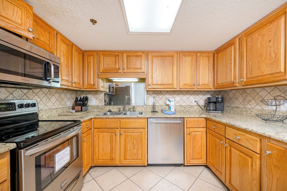 Cook up family favorites in the spacious kitchen, surrounded by warm wood cabinets and stainless appliances