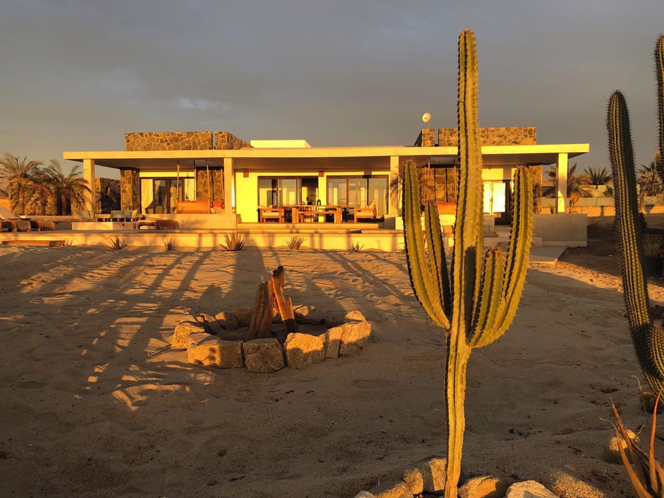 house with faux beach fire pit area