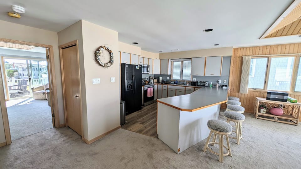 Large open kitchen next to great room and master bedroom leading to back balcony