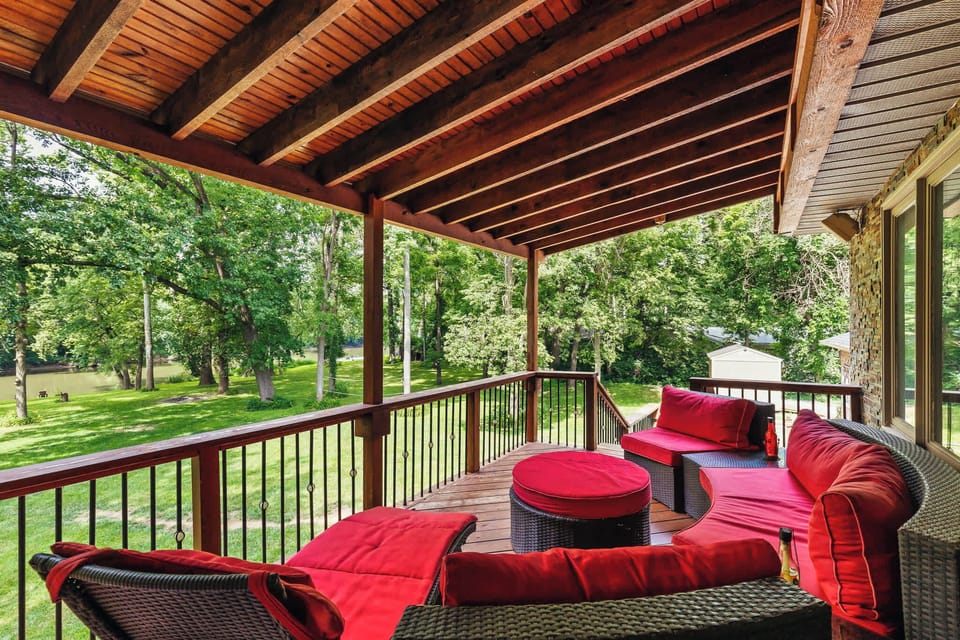 Multi-level covered decks featuring a gas grill, spacious outdoor dining table and lounge area- perfect for hosting family cookouts and group gatherings
