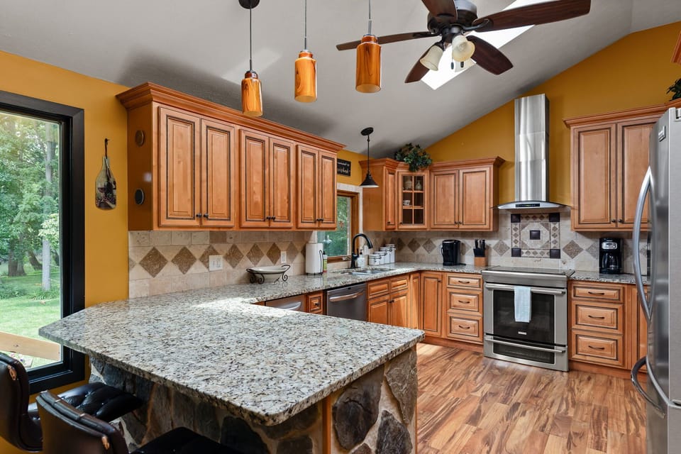 Open-concept chef's kitchen with breakfast bar seating